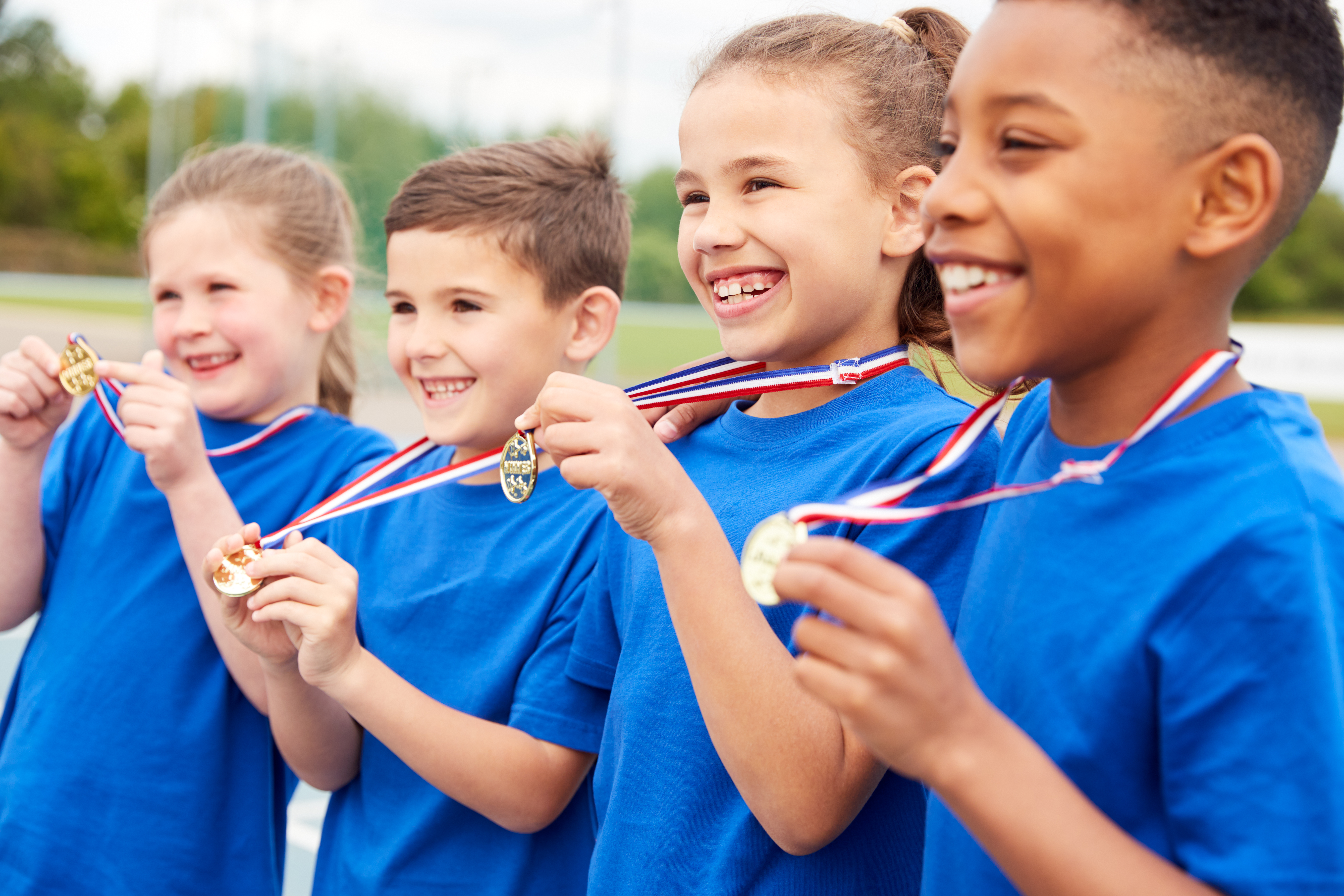 Children Showing Off Winners Medals On Sports Day